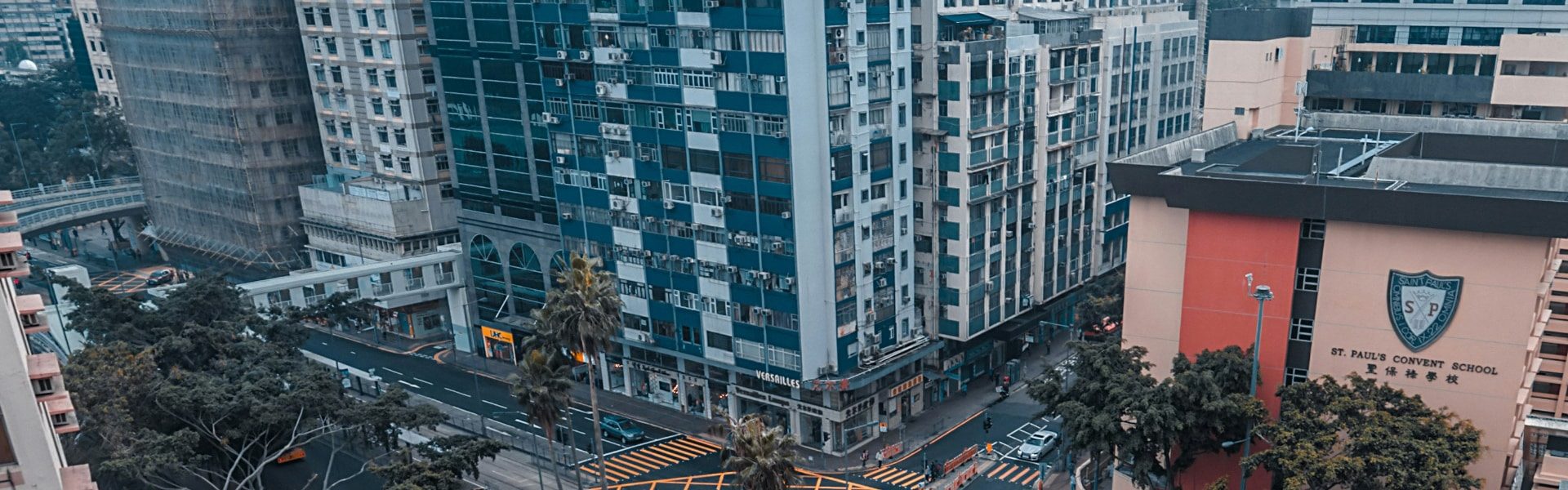 A view of a city street lined with mid-rise buildings